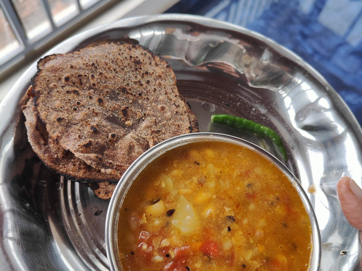 Home-cooked dal, ragi rotis and a wedge of lime.