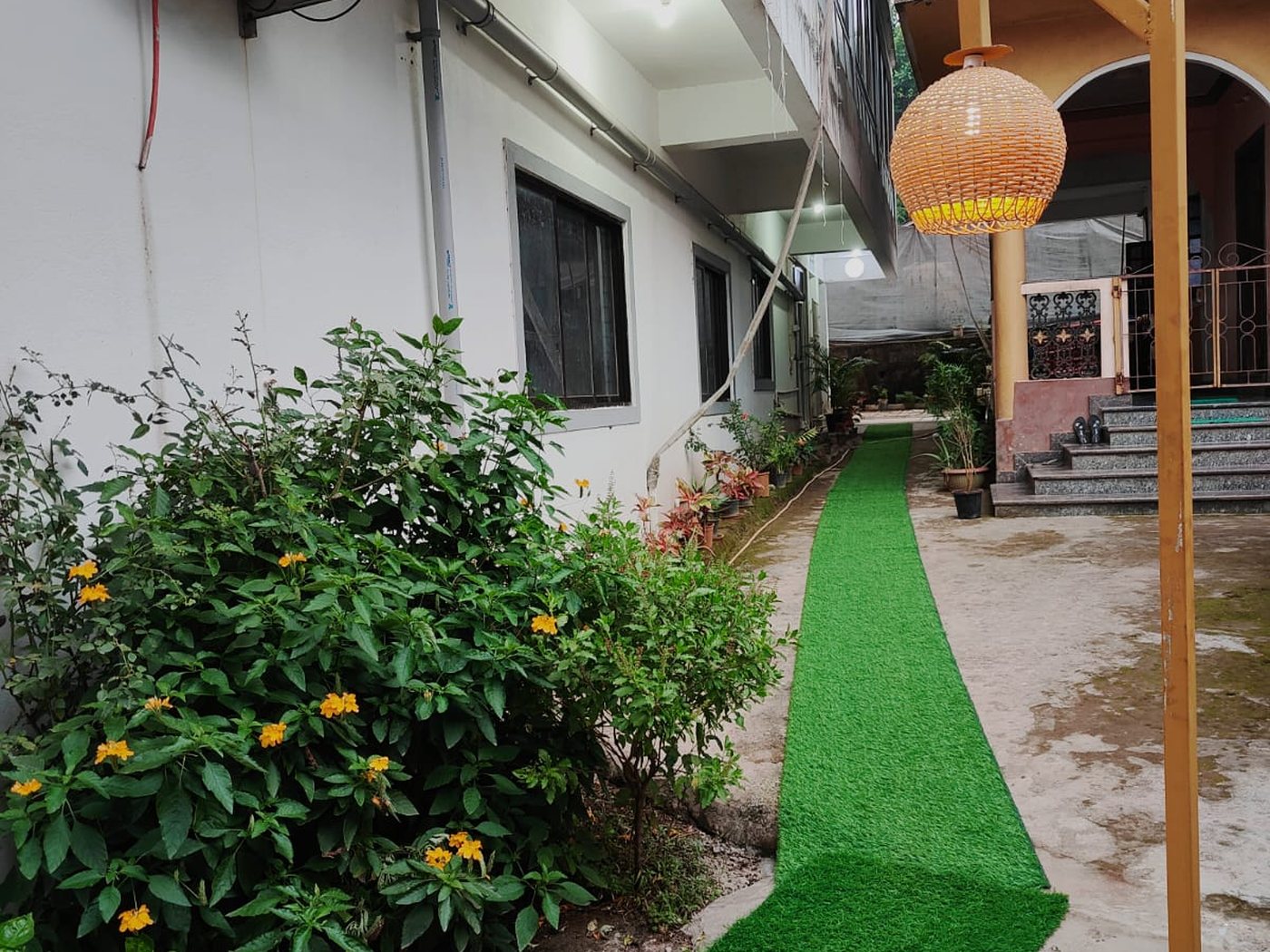 The garden path to the rooms, lit by a cane lantern.