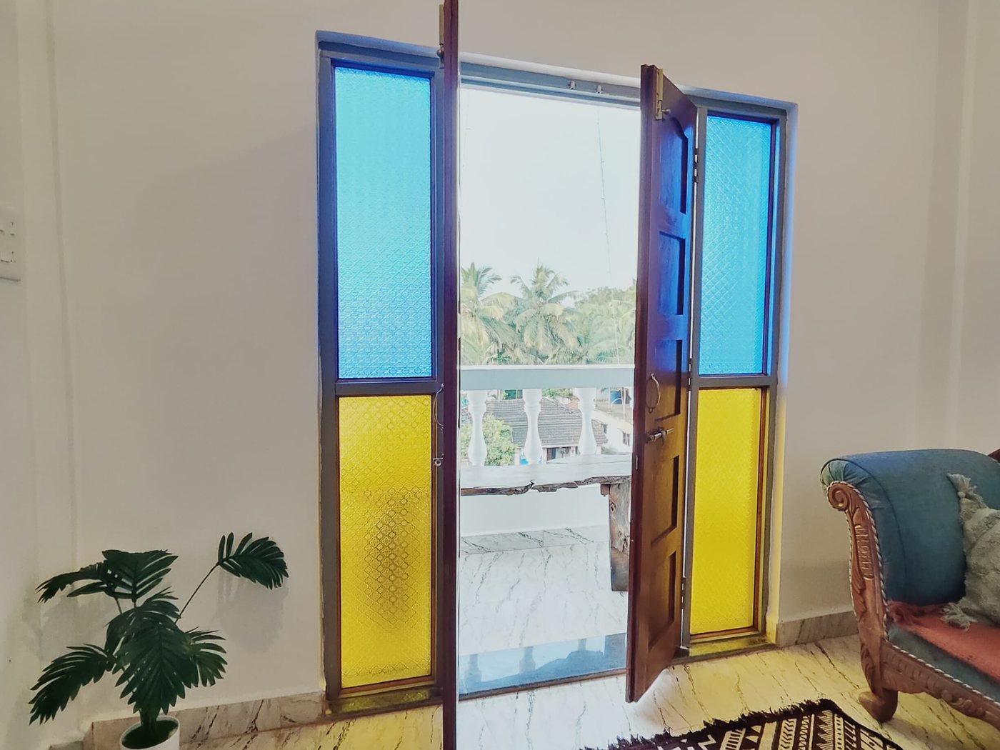 Tulasi room: stained-glass doors open to the balcony